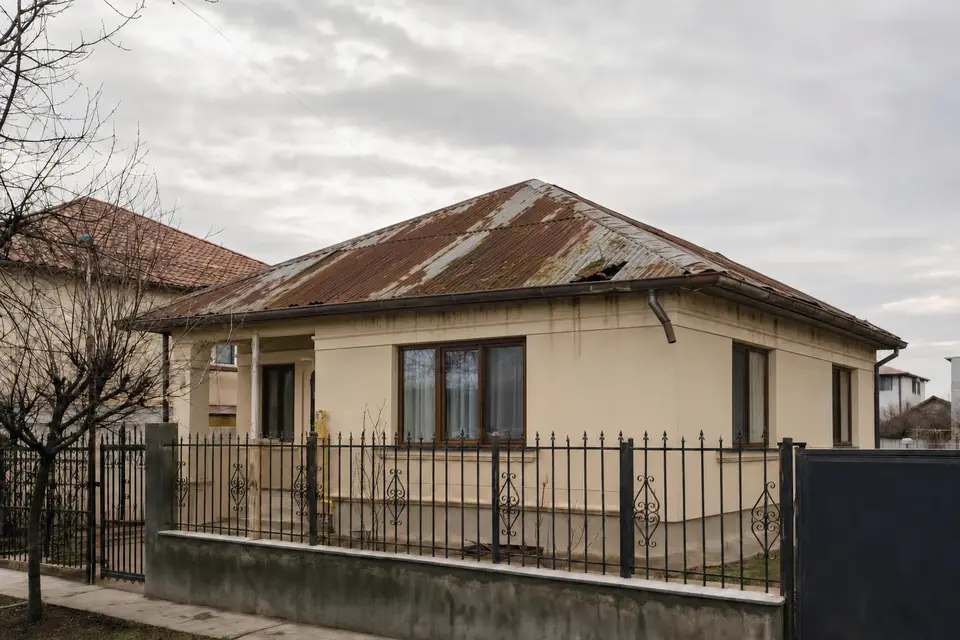 Acoperiș vechi din tablă ruginită, cu jgheab rupt — înainte (imagine ilustrativă)